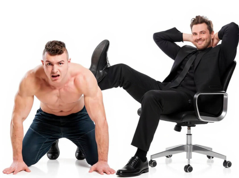 Human Furniture Symbolbild: Ein Mann sitzt auf einem Bürostuhl und benutzt einen anderen Mann mit nacktem Oberkörper als Tisch, um seine Beine darauf abzulegen. Human Furniture Symbolic image: A man sits on an office chair and uses another man with a bare chest as a table to rest his legs on.